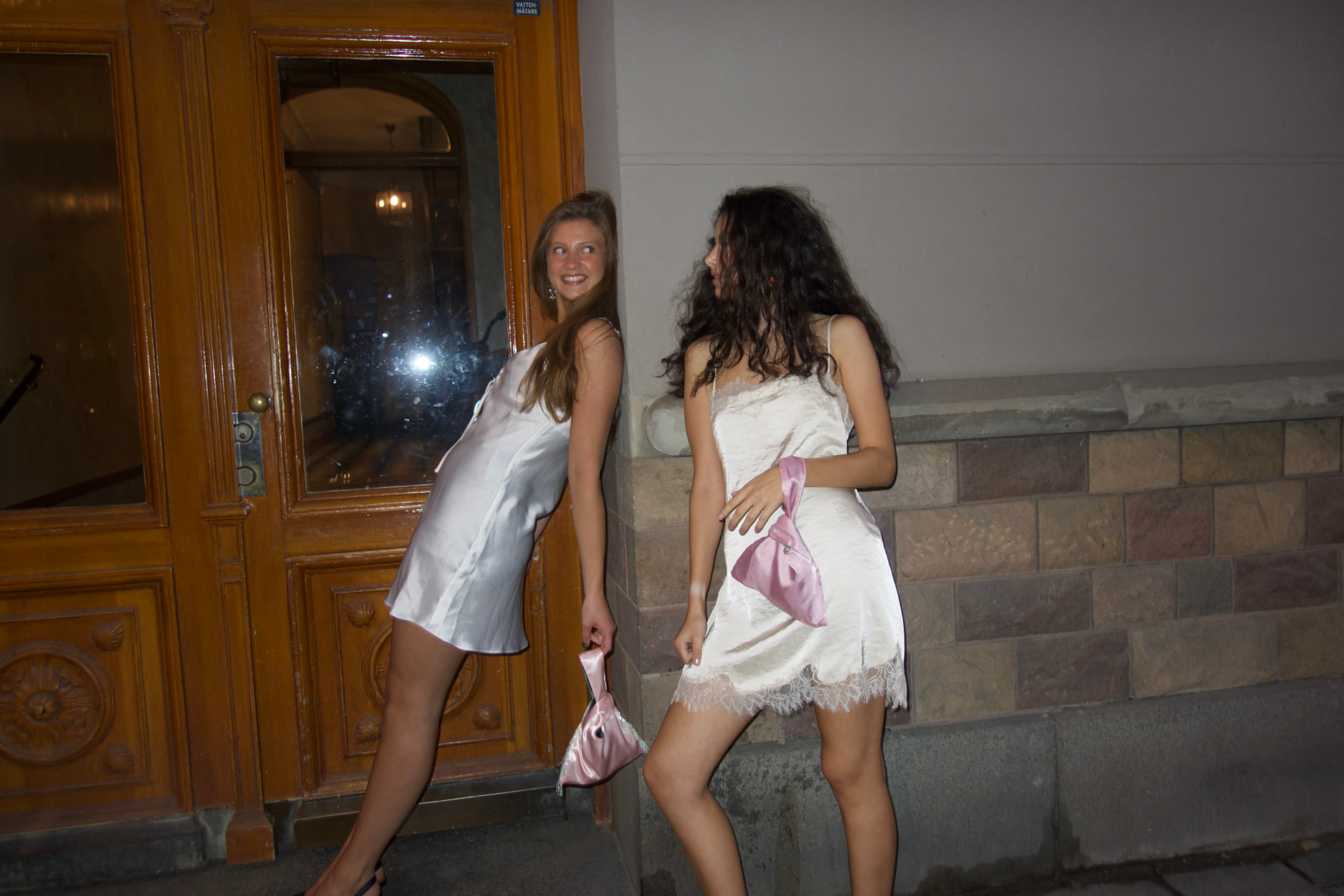 Friends posing with Stella bags at night
